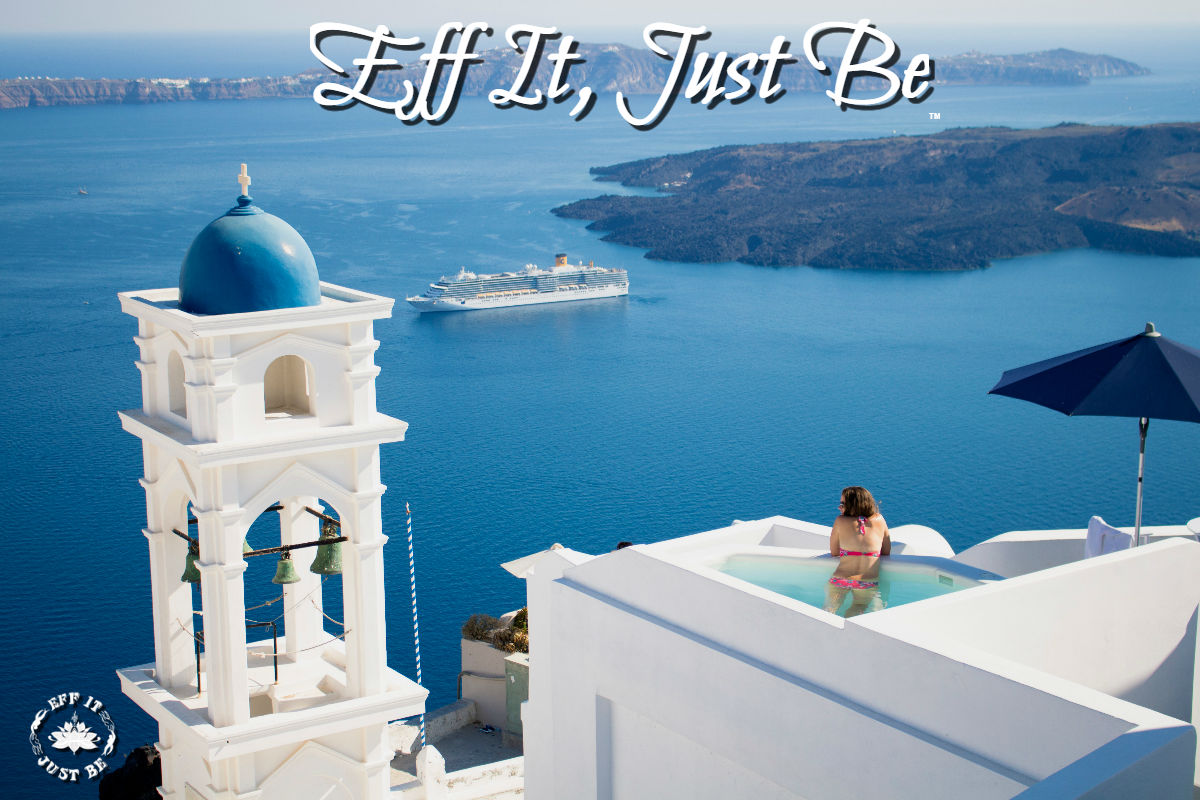 woman in balcony overlooking the Aegean sea in Santorini island as a cruise ship sails by